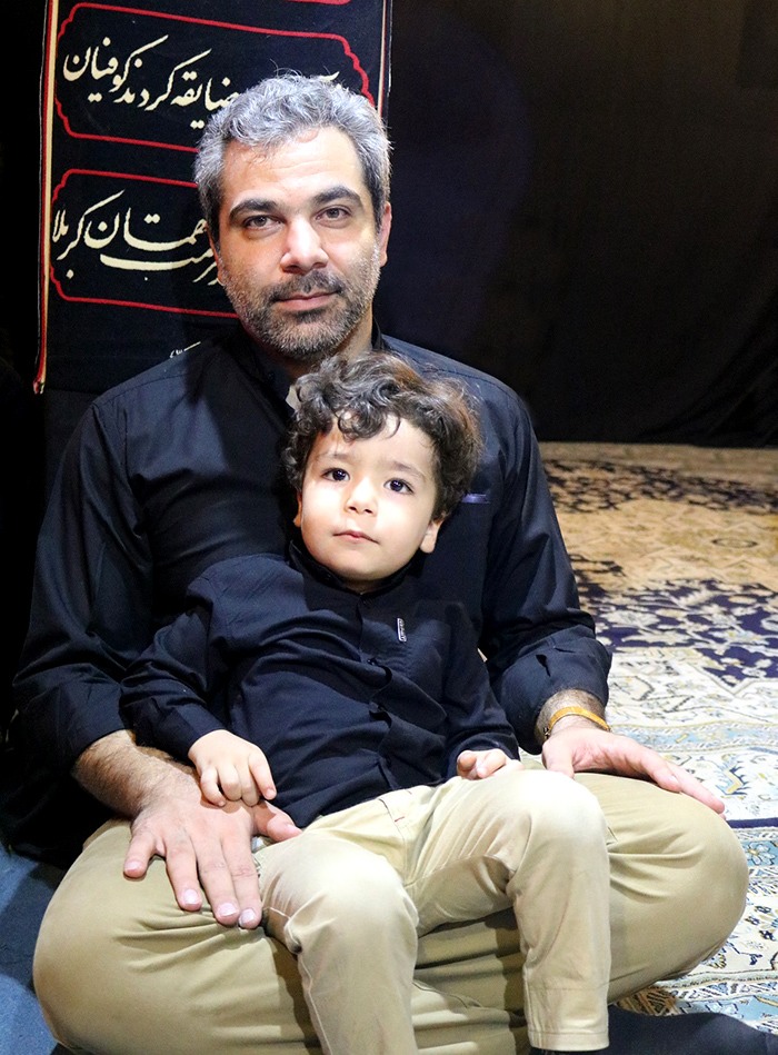 father and child in the House of mourning for Hussein in Celebration of Ashura 2017